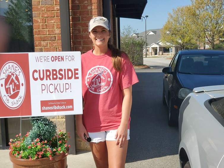 Shack Crew Member delivering Curbside Orders to customers.